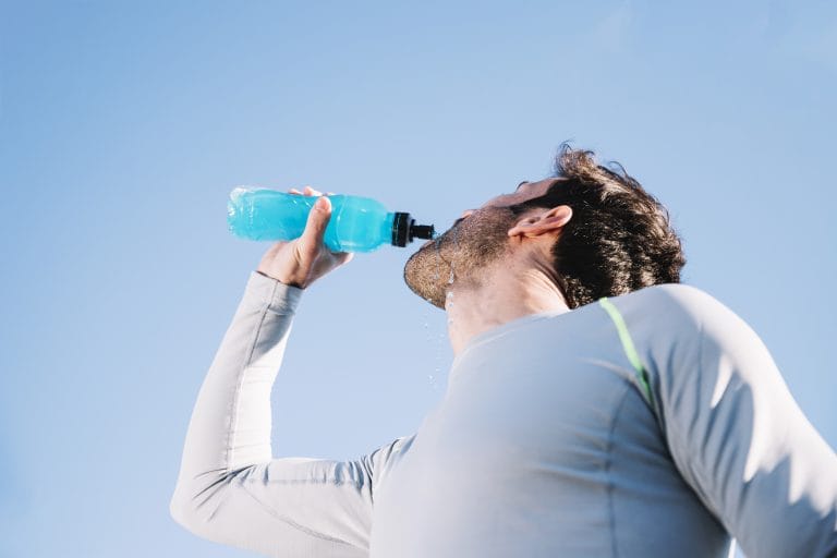 sporty man drinking water scaled